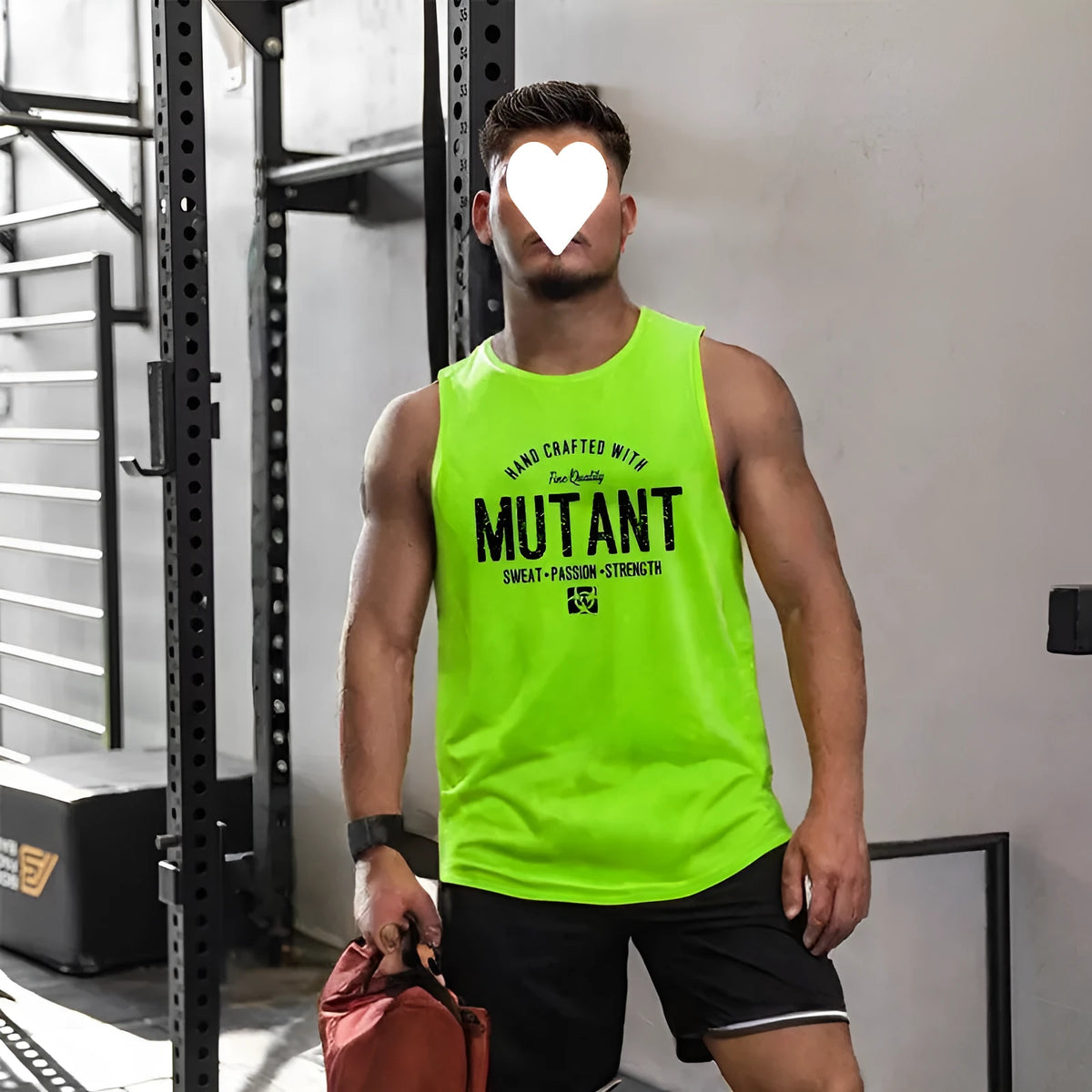 Man wearing a loose fit black and yellow sleeveless training vest for gym workouts.