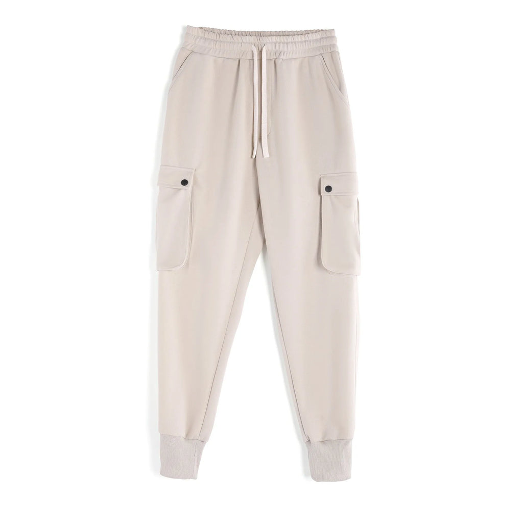 Men's loose grey cotton sports trousers with ankle ties and multiple pockets laid flat.