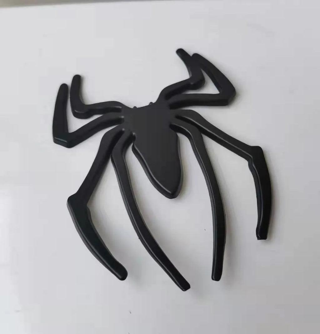 Three-dimensional zinc alloy spider bumper sticker in gold colour measuring 7cm by 5cm