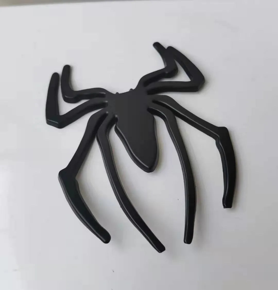 Three-dimensional zinc alloy spider bumper sticker in gold colour measuring 7cm by 5cm