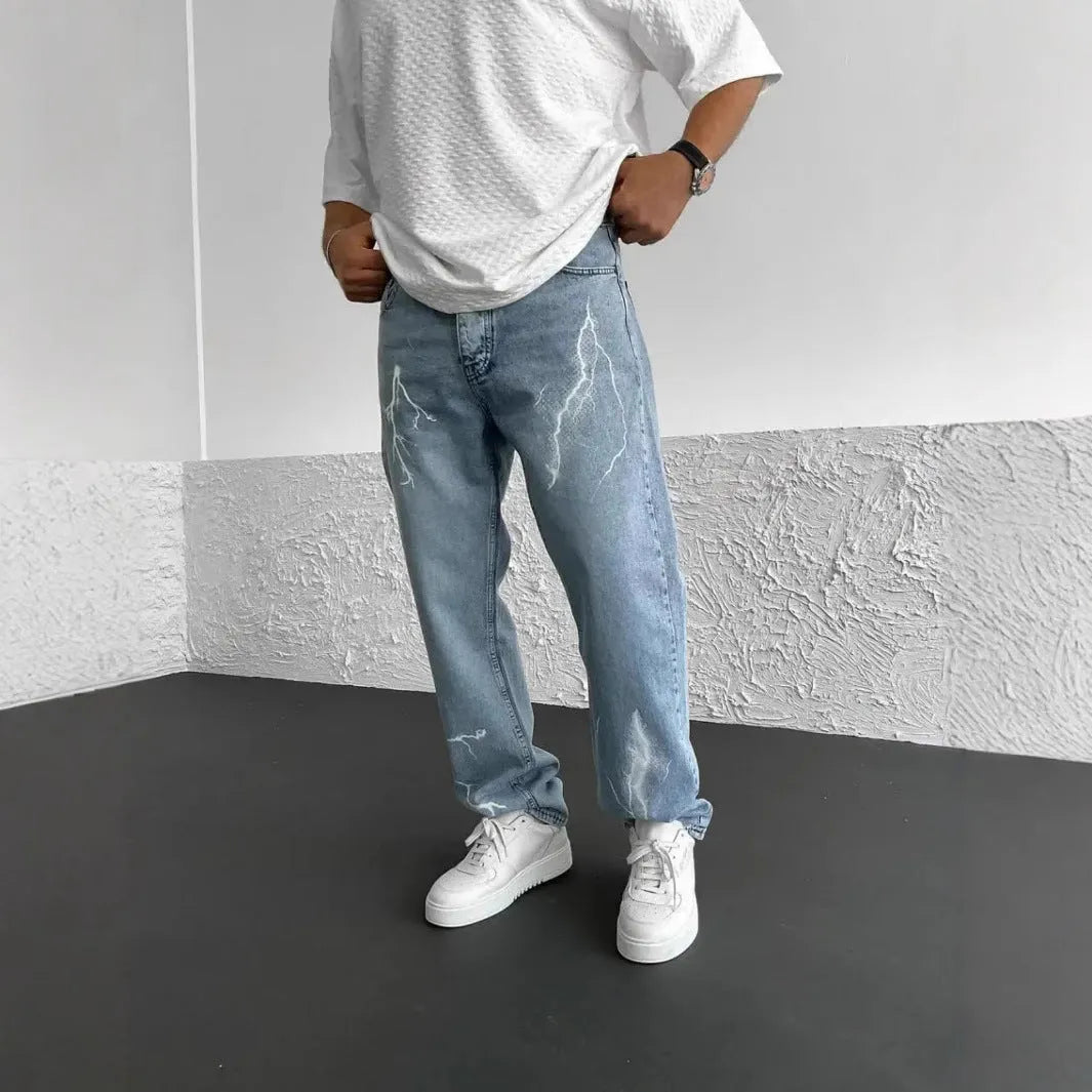 Men's blue straight-leg denim jeans with loose wide-leg cut and zip fly