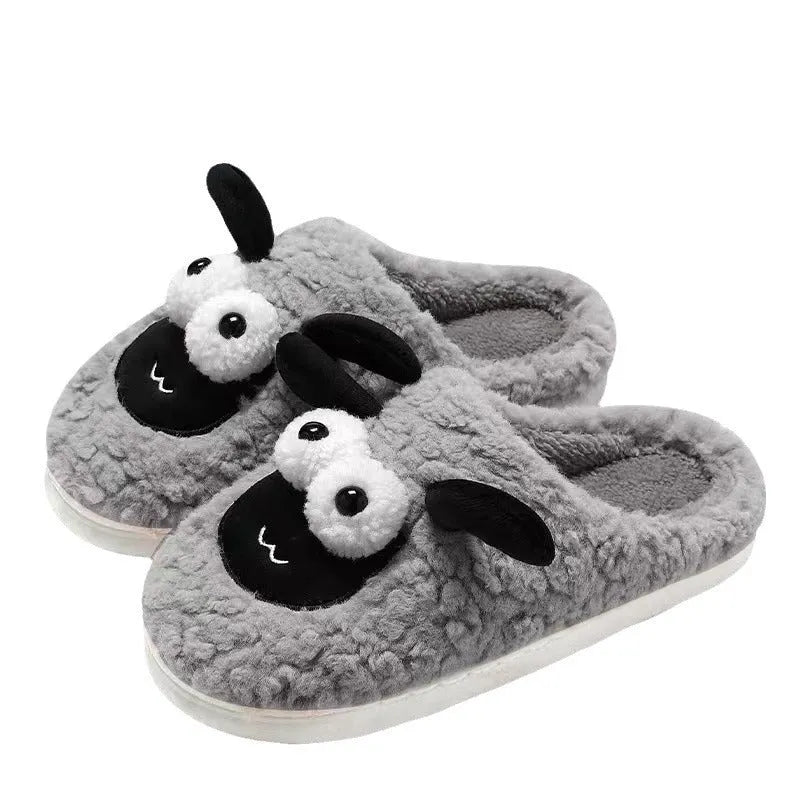 Brown suede slip-on slippers with thermal lining on a wooden floor