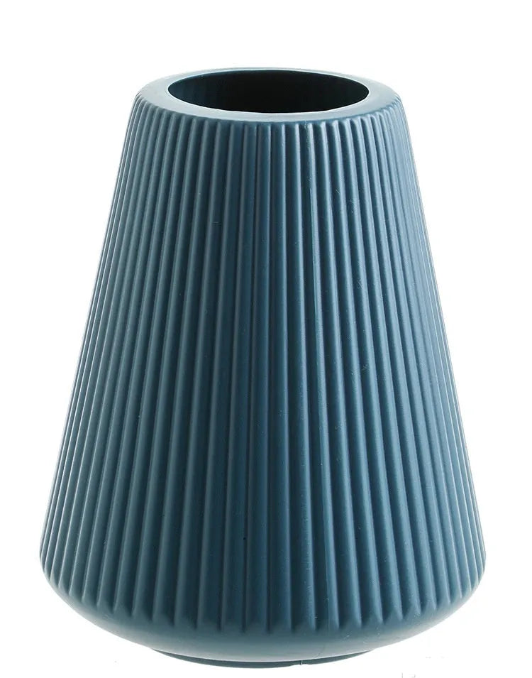 Colourful melamine plastic decorative flower vase on a tabletop.