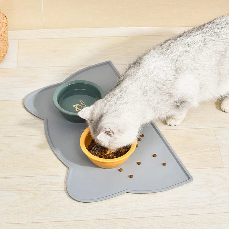 Blue waterproof silicone pet feeding mat for dog and cat bowls on a wooden floor