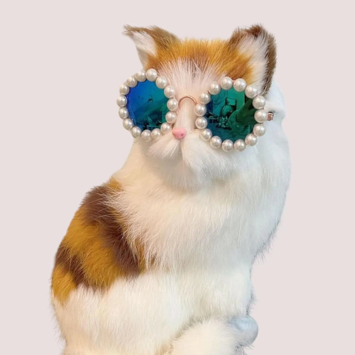 Pearl-rimmed round sunglasses for cats and dogs on a coloured background.