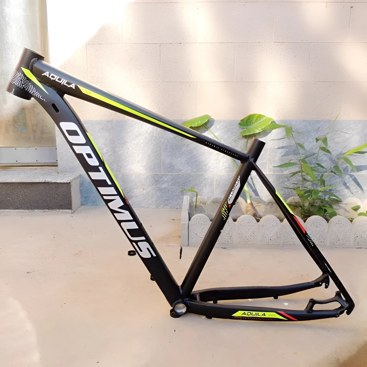 Black green aluminium 29-inch mountain bike frame showing disc brake mount and internal cable routing ports.
