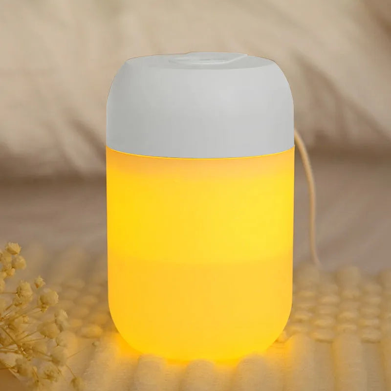 White cylindrical USB mini humidifier with charging cable on flat surface