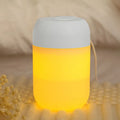 White cylindrical USB mini humidifier with charging cable on flat surface