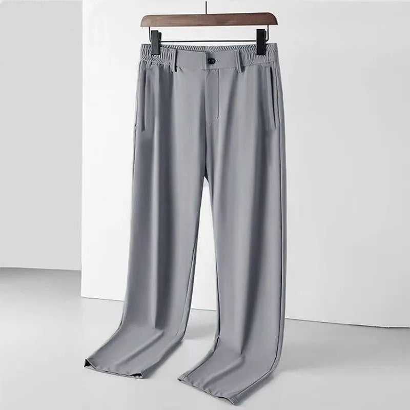 Man wearing black Ice Silk straight leg casual trousers with an elasticated waist.