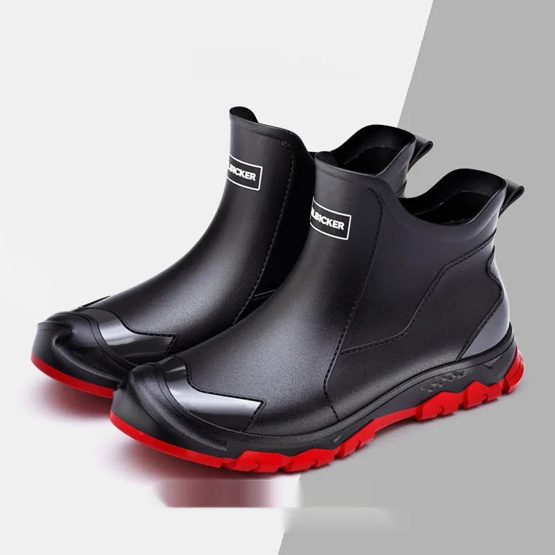 Short tube black PVC rain boots with round toe and flat heel on a non-slip plastic sole.