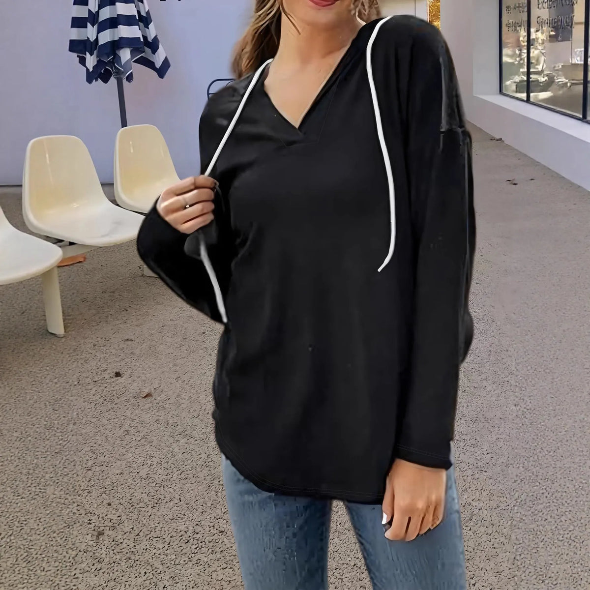 Red women's V-neck hooded sweatshirt with long sleeves on a hanger