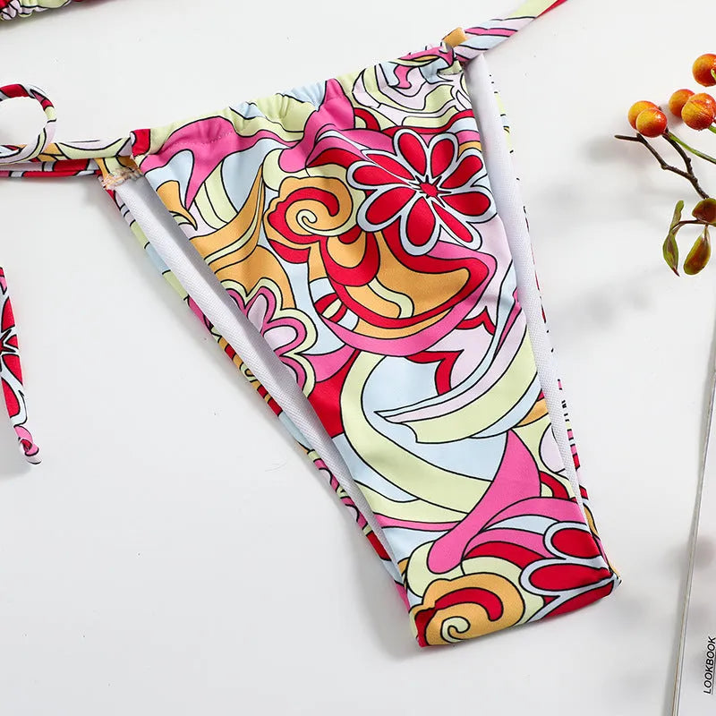 Women's multicolour printed triangle bikini top with hanging neck and matching briefs.