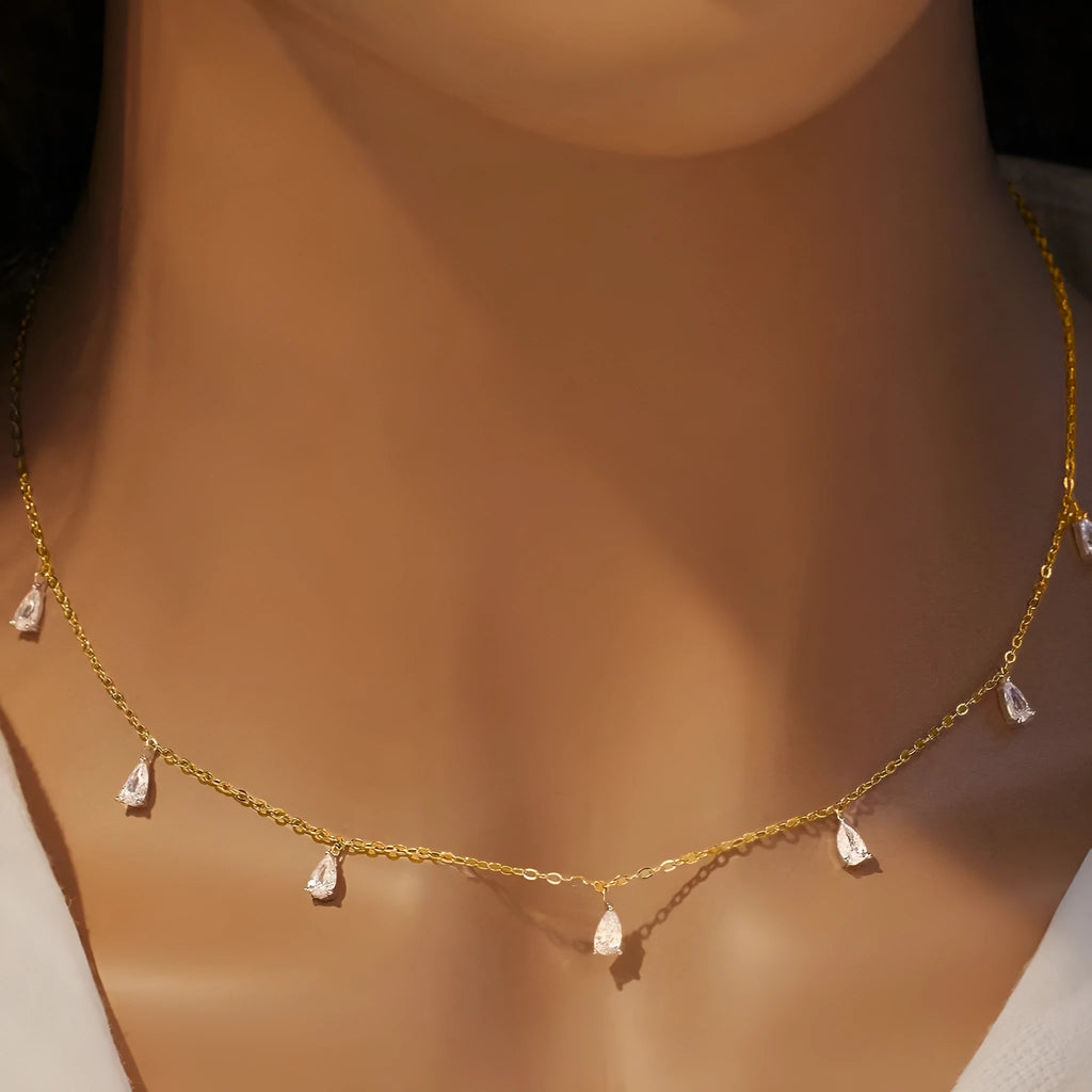 Gentle drop-shaped silver necklace with triangular details on an adjustable O-chain, shown in rose gold finish.