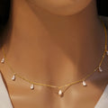 Gentle drop-shaped silver necklace with triangular details on an adjustable O-chain, shown in rose gold finish.
