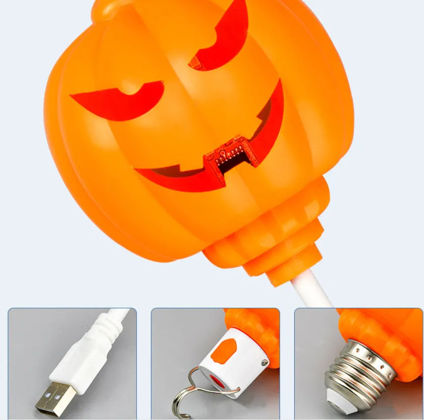 Plastic pumpkin-shaped USB rechargeable lamp glowing with either yellow or purple light, measuring 22cm tall.