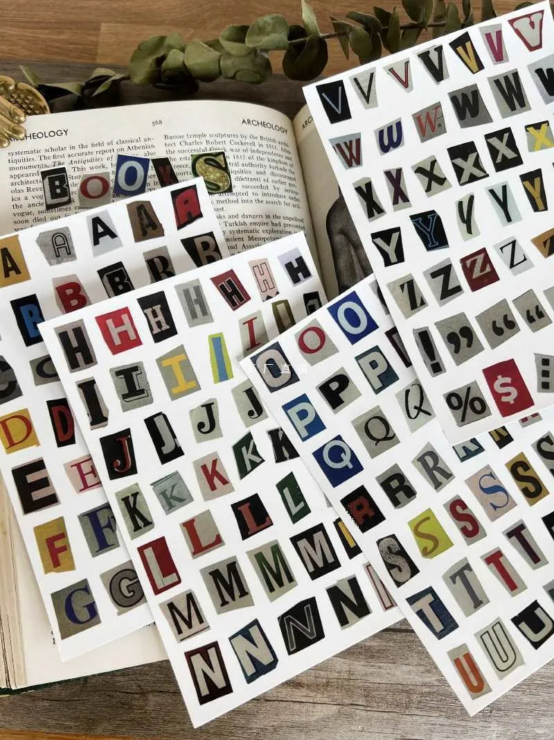 Set of printed cute-style stickers showing English letters, numbers, and weekday words on a sheet.