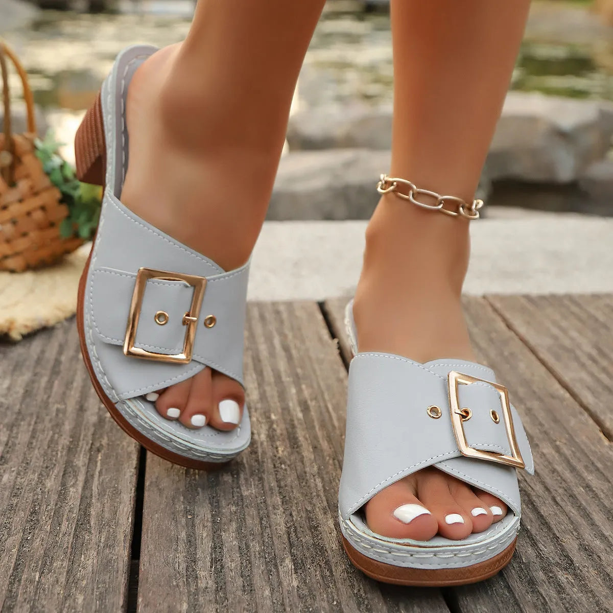 Women's black retro chunky heel beach slippers with a metal buckle detail on the upper.