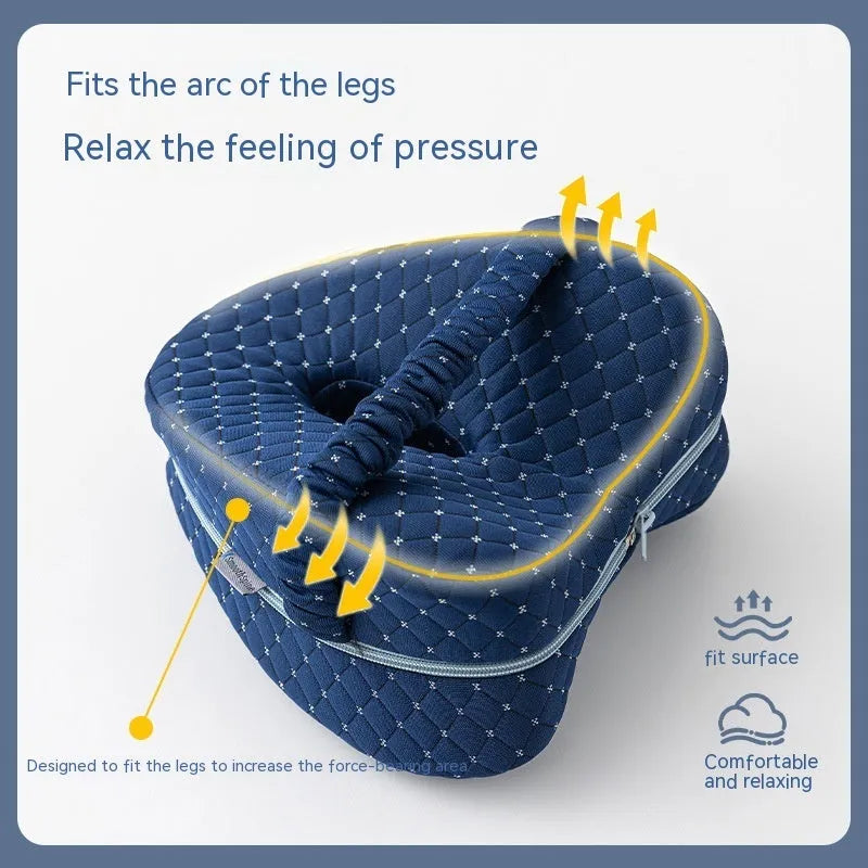 Dark blue jacquard love heart-shaped memory foam leg pillow on a grey sofa