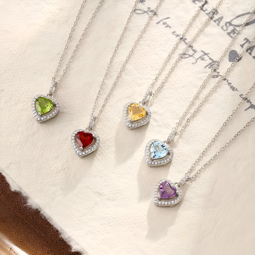 Sterling silver heart necklace with a purple amethyst gemstone on a textured cross chain