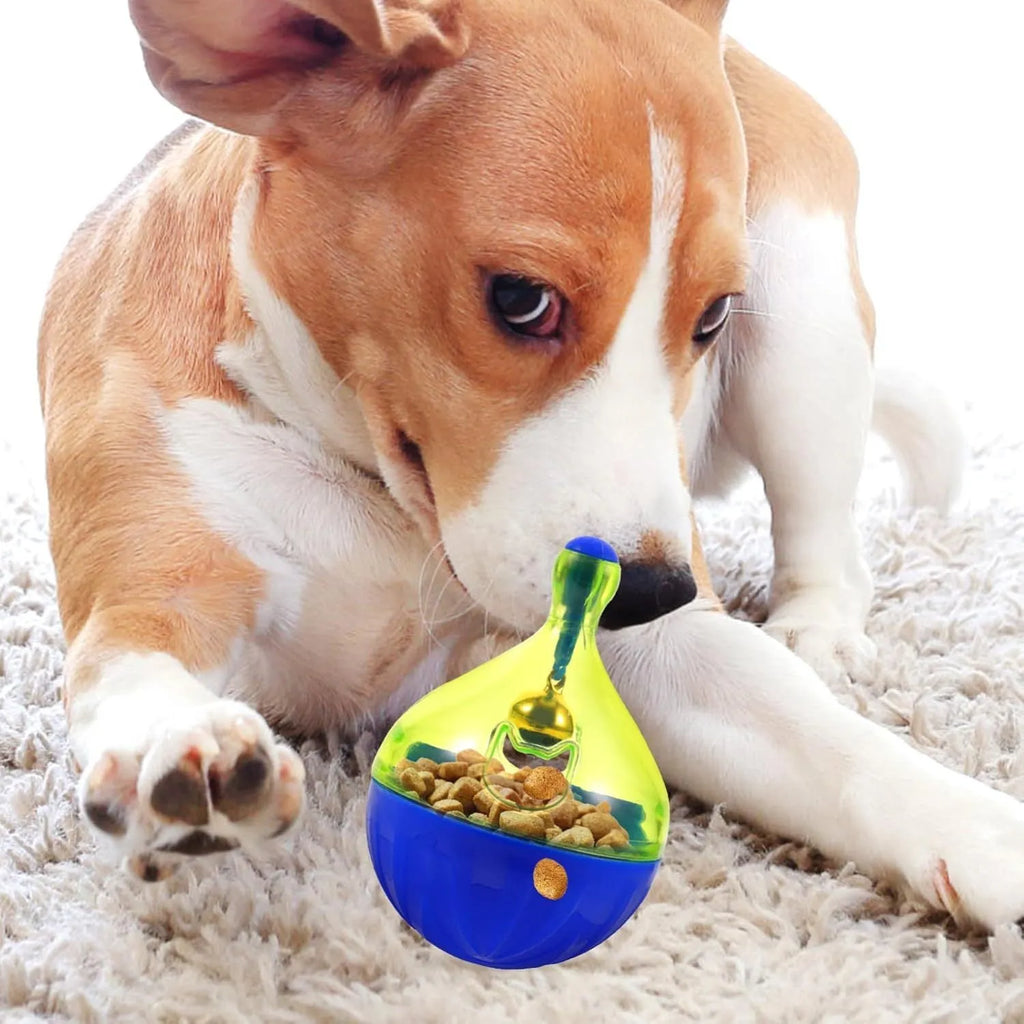 Blue and white tumbler-shaped dog and cat treat dispenser puzzle toy on a wooden floor.