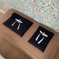 Women's black quilted computer bag with ballet style bow and striped pattern