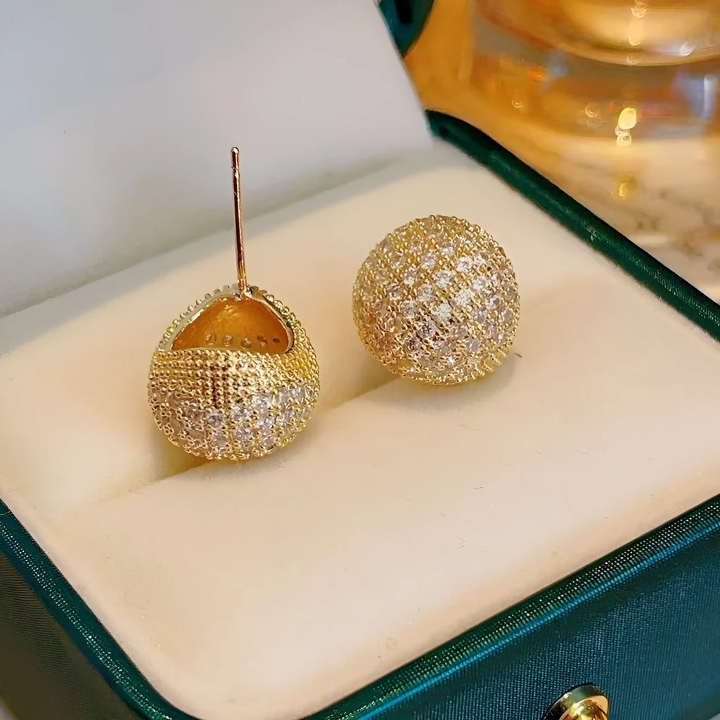 Gold and white women's drop earrings with geometric sphere and diamond-cut golden bean design