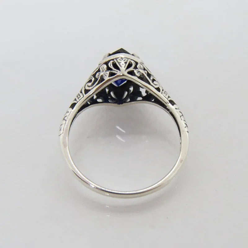 Women's silver geometric hollow ring with zircon stone on alloy band.