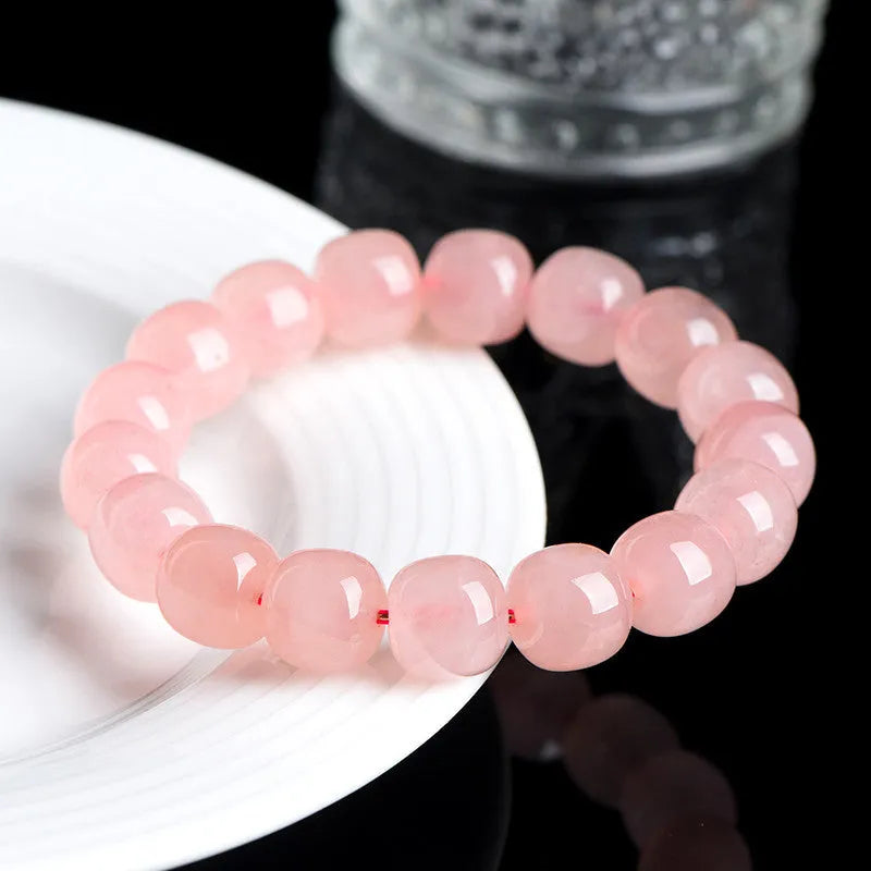 Pink natural crystal barrel bead bracelet with polished 8-10mm gemstone beads on wrist