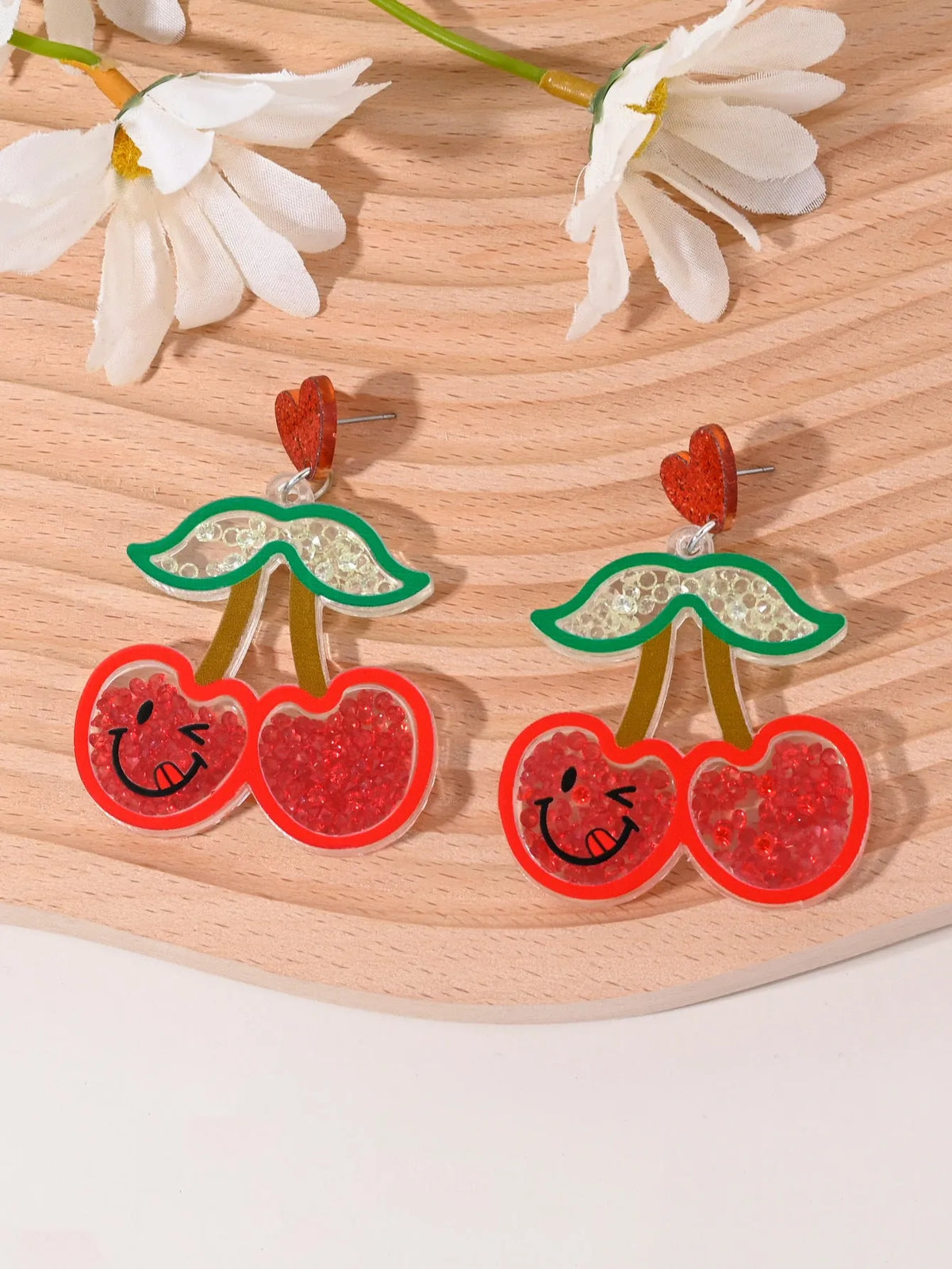 A pair of acrylic earrings shaped like a cherry, strawberry, watermelon, pineapple, coconut cake, or ice cream.