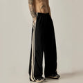 Black men's wide leg climbing trousers with a high waist and straight leg on a mannequin.