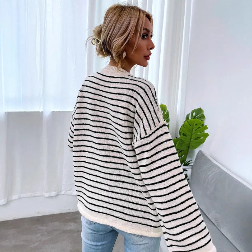Black striped women's knitted top with drop shoulder sleeves on hanger