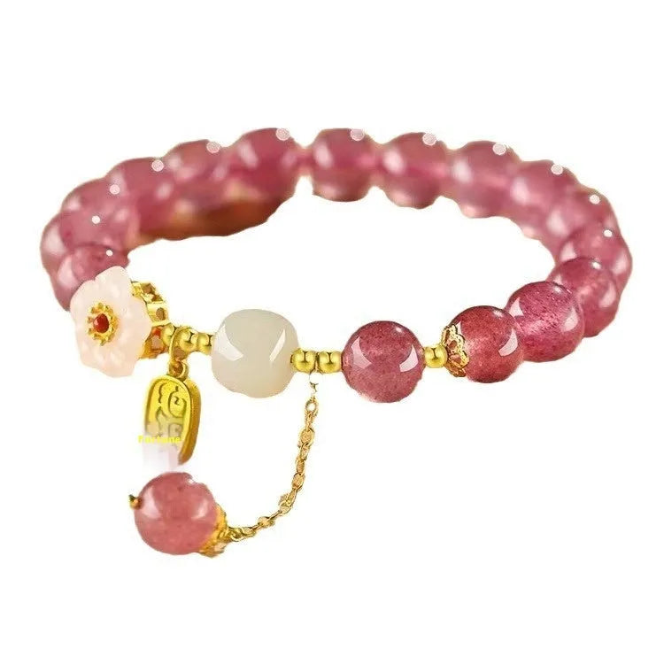 Handmade women's strawberry quartz crystal bracelet with pearl, moon, and XINGX designs