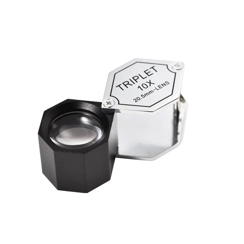 Handheld metal portable magnifying glass for jewellery and coin inspection with optical glass lenses.