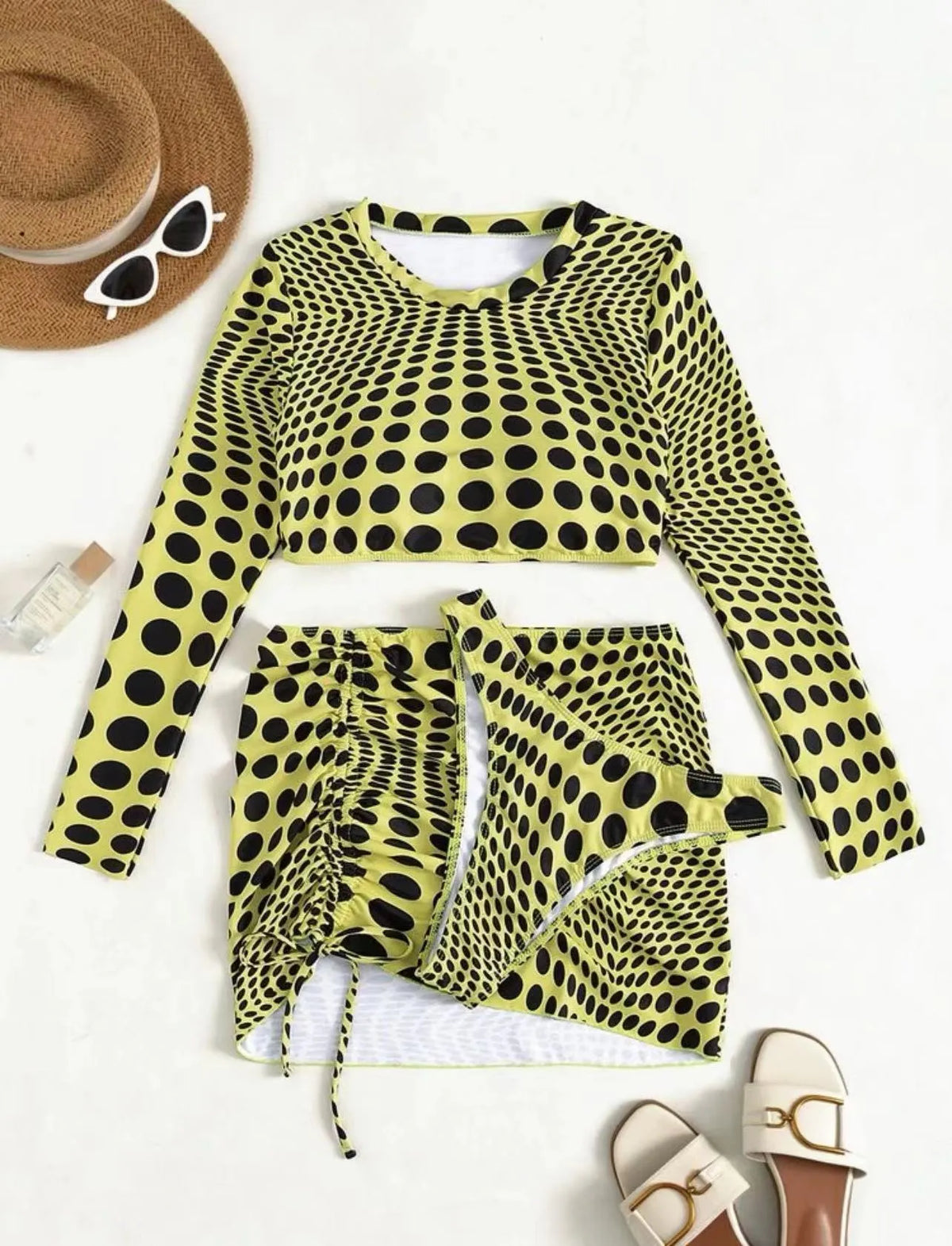 Women's green polka dot swimsuit three-piece set with bra, top and skirt on hanger