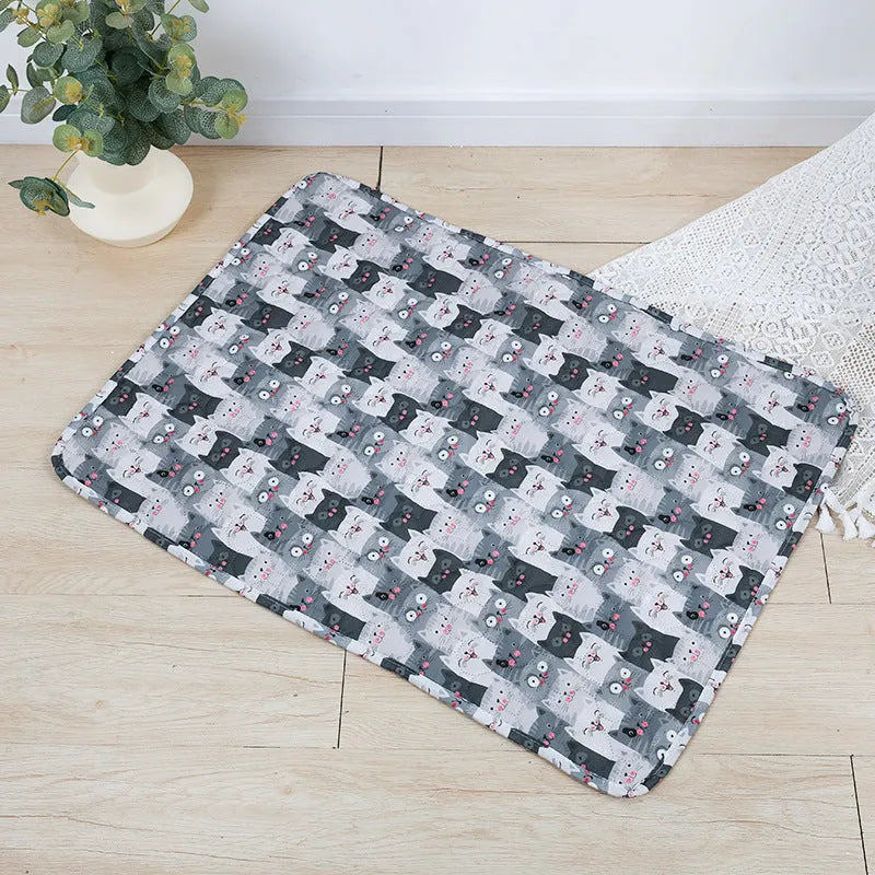 Reusable washable pet urine pad with non-slip backing in Animal World pattern, laid flat on floor.