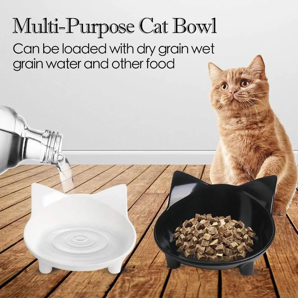 Set of four white shallow melamine pet bowls with black non-slip rubber bases on a table.