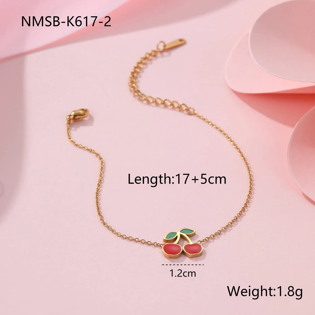 Cherry jewellery set showing necklace, bracelet, earrings, and ring with stainless steel construction and gold plating