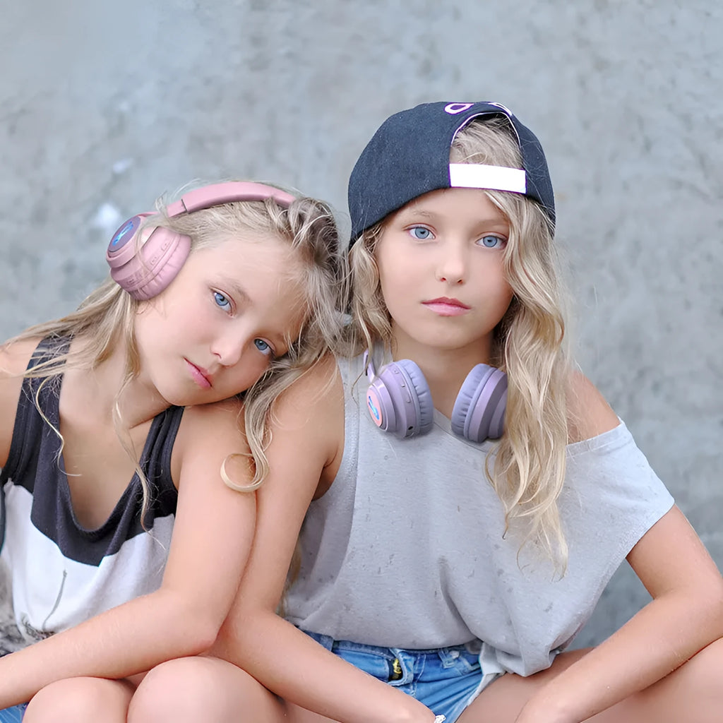 Children's wireless headphones with RGB LED lights in bunny pink colour showing Bluetooth connectivity