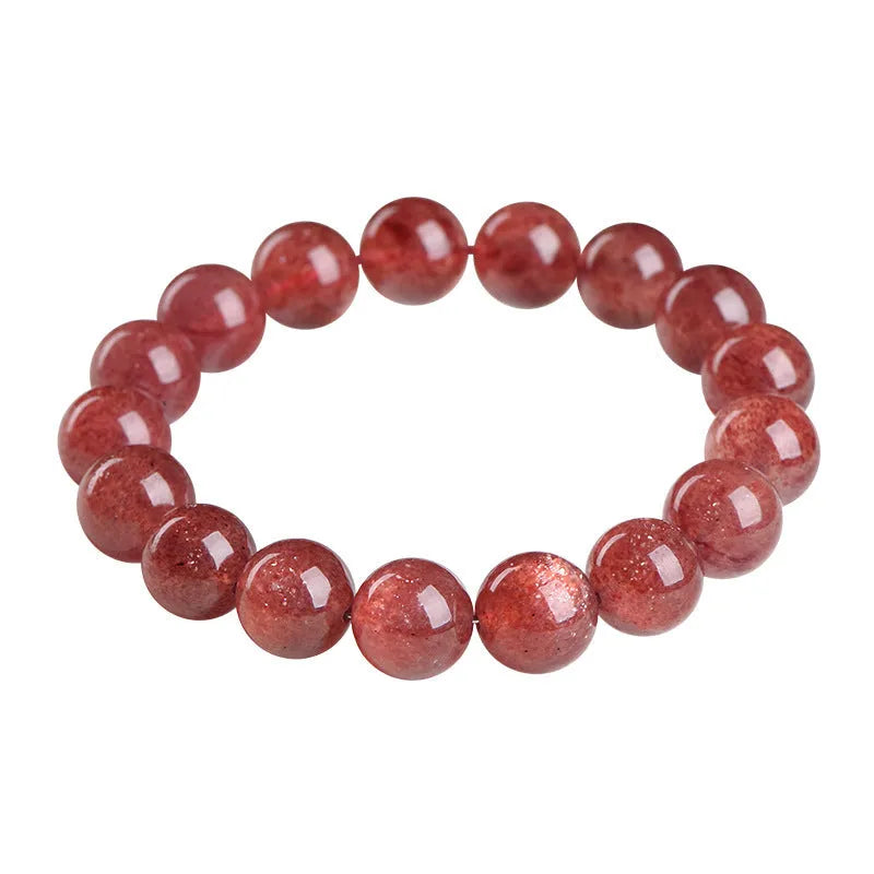A strawberry quartz bracelet with geometrically cut, cherry red crystal beads on a black background.