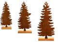 Three rusty metal Christmas decorations featuring elk and trees on a wooden surface