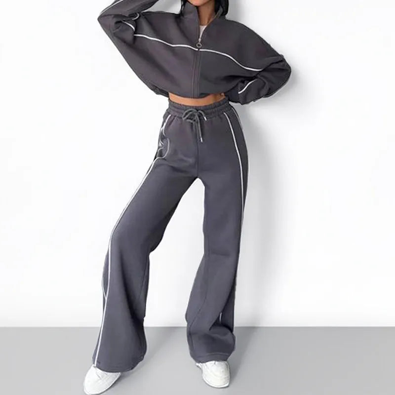 Casual two-piece suit set with a mock neck zip hoodie and striped trousers on a hanger.