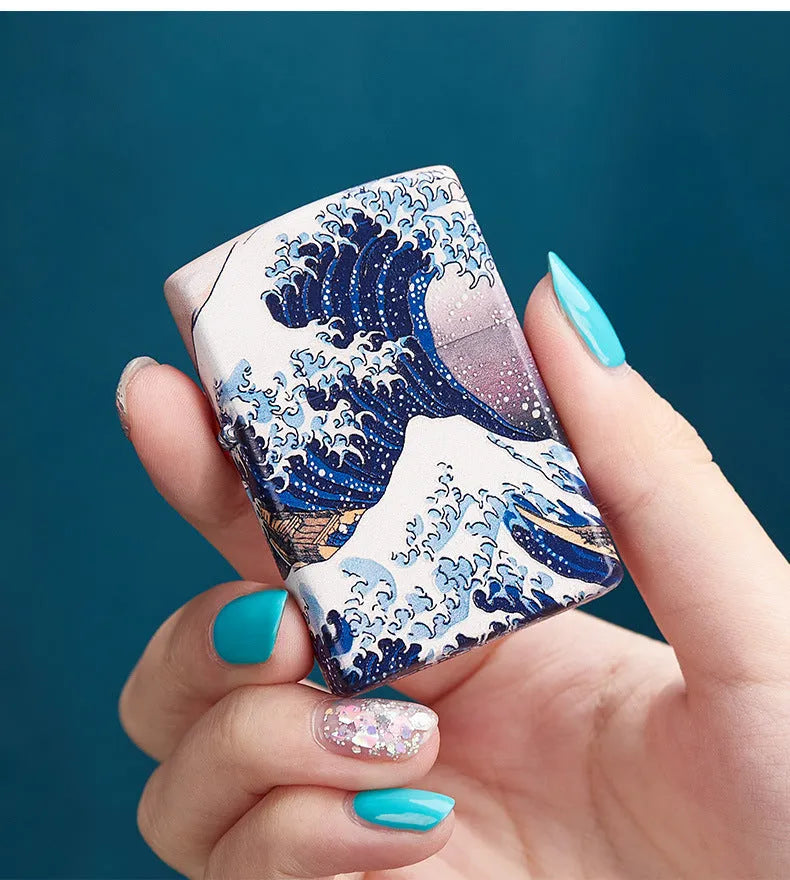 Coloured lacquer windproof lighter with Kanagawa surf design, steel inner liner, copper housing, 58 x 39 x 13mm.