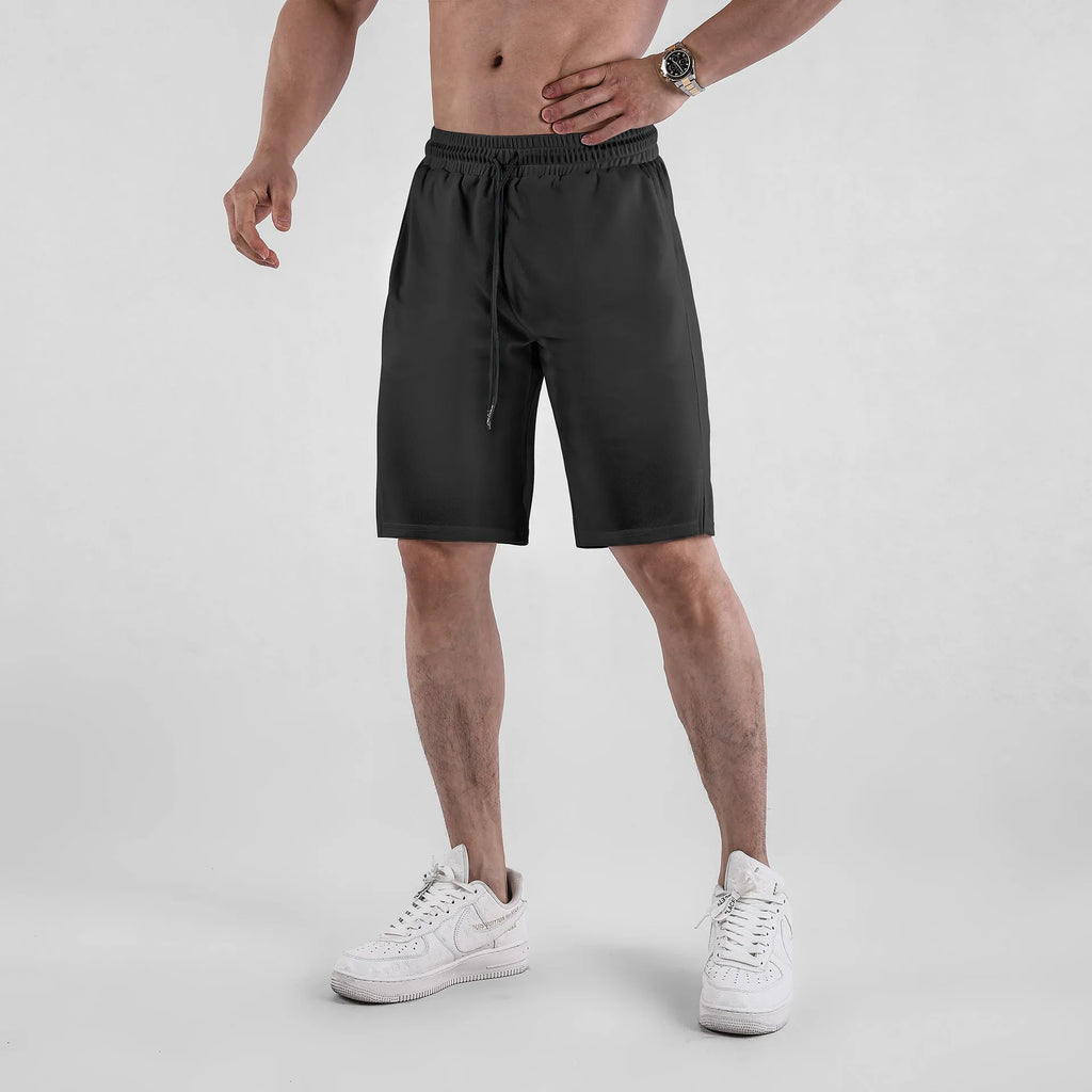 Men's black quick-drying mesh capri shorts with an elastic mid waist on a white background.