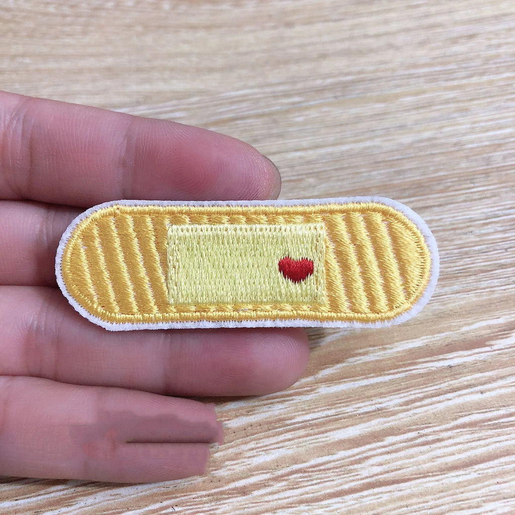 A pack of ten computer-embroidered fabric patches with lace craft detailing, showing four different design styles.