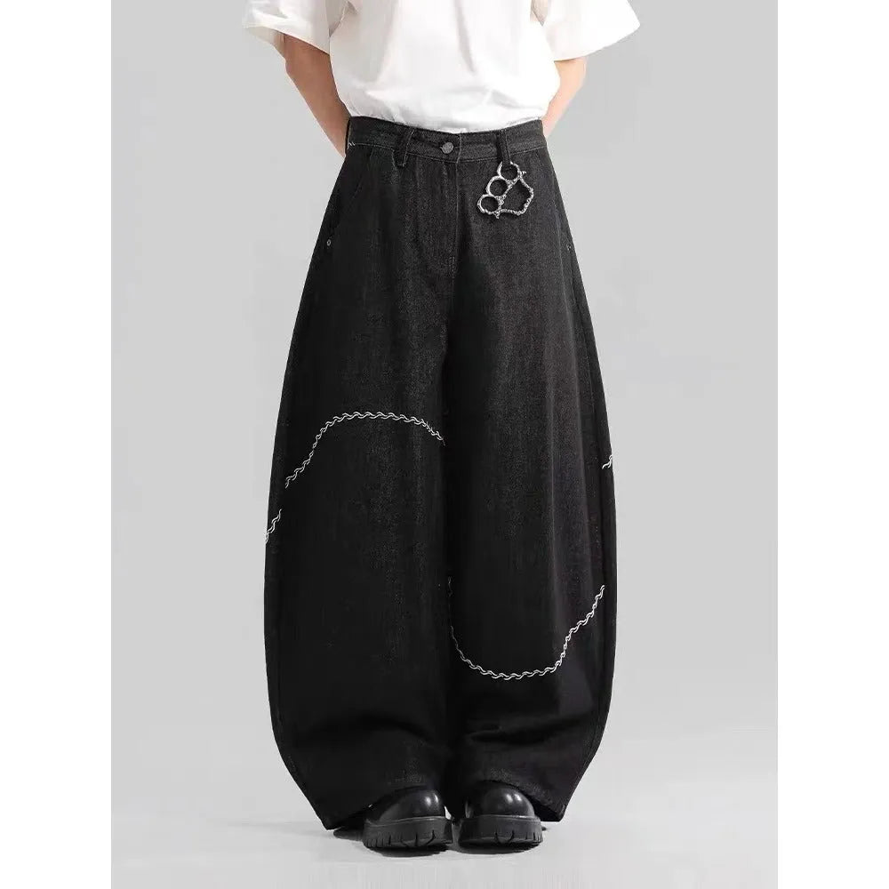 Black straight-leg denim trousers with a mid-waist and zip fly on a plain background.