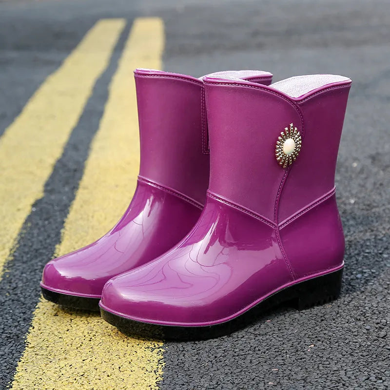 Women's purple PVC rain boot with non-slip sole and middle tube height.
