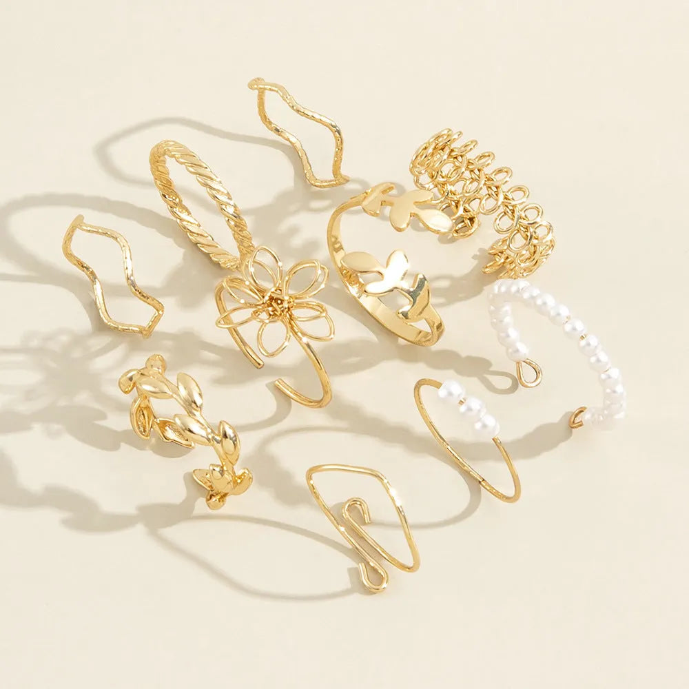 Gold colour openwork flower set ring with detailed floral design and glossy electroplated finish