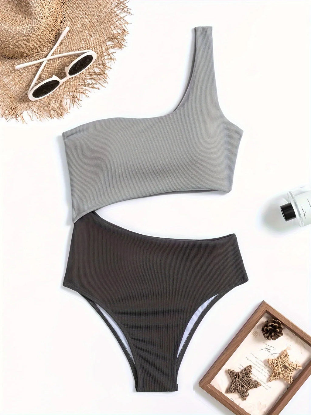 Light grey one-shoulder one-piece swimsuit on a mannequin, front view.