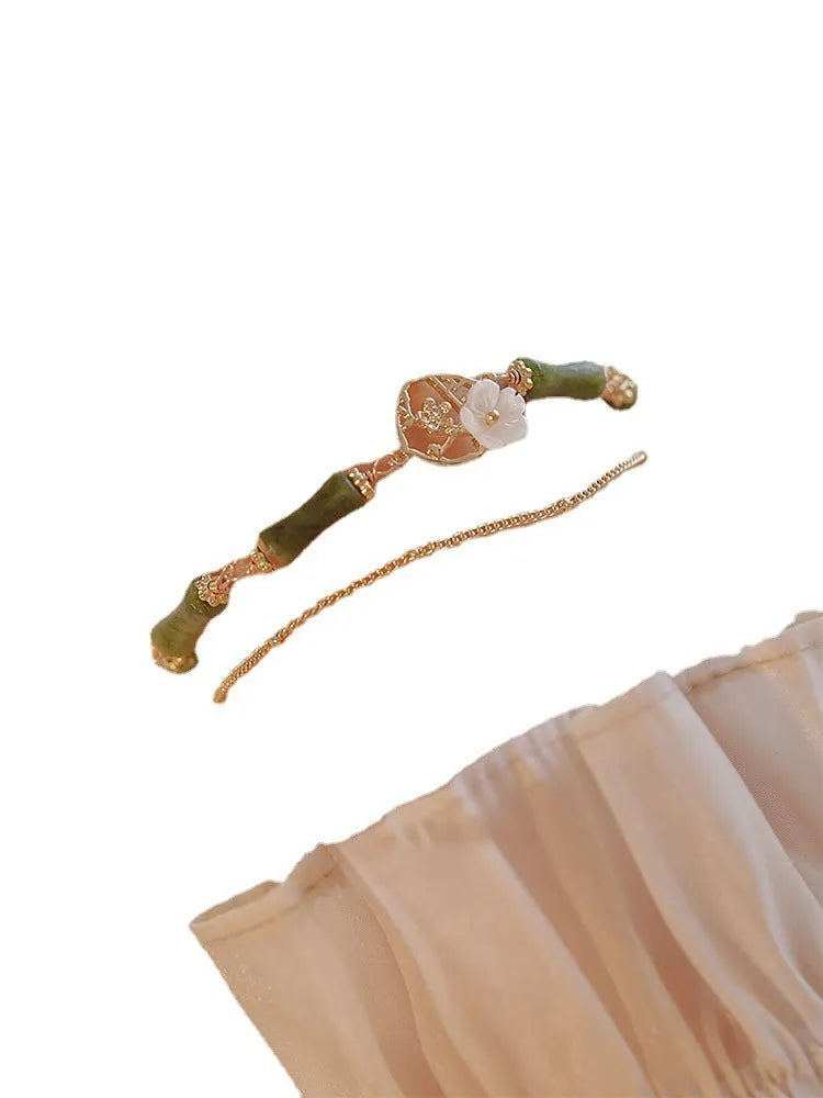 Natural green olivine stone bracelet with double layer Twin Bells of Ireland and Olive Branch design on an adjustable band.