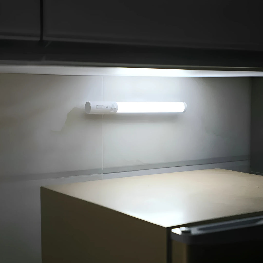 Long white LED human body induction cabinet light with magnetic strip on back for wall or wardrobe mounting.